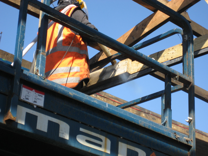 timber roof frame being blasted